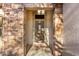 Welcoming front entrance with a decorative security door and stone accents creating an elegant curb appeal at 19793 N Tapestry Ct, Surprise, AZ 85374