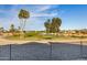 Scenic view of the golf course from the backyard, featuring manicured greens and a serene lake at 19793 N Tapestry Ct, Surprise, AZ 85374