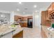 Spacious kitchen with granite countertops, oak cabinetry, and stainless appliances at 19793 N Tapestry Ct, Surprise, AZ 85374