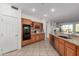 Bright eat-in kitchen with built-in oven, wooden cabinetry and granite countertops at 19793 N Tapestry Ct, Surprise, AZ 85374