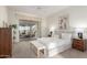 Bright main bedroom featuring neutral colors, a ceiling fan, and sliding glass doors to a porch at 19793 N Tapestry Ct, Surprise, AZ 85374