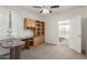 Home office featuring built-in shelving, a desk, neutral carpet and a doorway to another room at 19793 N Tapestry Ct, Surprise, AZ 85374