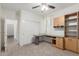 Office showcases neutral carpet, built-in desk and shelving, with a view into an adjacent room at 19793 N Tapestry Ct, Surprise, AZ 85374