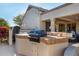 View of a covered outdoor kitchen featuring a built-in barbeque and countertop at 19793 N Tapestry Ct, Surprise, AZ 85374