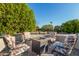 View of a cozy outdoor seating area with a fire pit and four cushioned chairs at 19793 N Tapestry Ct, Surprise, AZ 85374