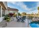 Covered patio with outdoor seating, a view of the pool, and beautiful landscaping at 19793 N Tapestry Ct, Surprise, AZ 85374