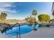 Backyard swimming pool features rock features and views of community lake and golf course at 19793 N Tapestry Ct, Surprise, AZ 85374