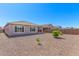 A fenced backyard featuring gravel and a small patio area, offering a low-maintenance outdoor space at 22854 E Pummelos Rd, Queen Creek, AZ 85142