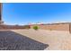 Wide backyard with low maintenance gravel, offering ample space and privacy for outdoor enjoyment at 22854 E Pummelos Rd, Queen Creek, AZ 85142