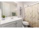 Clean bathroom featuring a white vanity and floral shower curtain at 22854 E Pummelos Rd, Queen Creek, AZ 85142