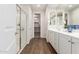 Bathroom featuring wood-look floors, double sinks, and a glass-enclosed shower at 22854 E Pummelos Rd, Queen Creek, AZ 85142