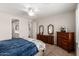 Bedroom with ceiling fan and view of bathroom, walk-in closet, carpet floors, and neutral walls at 22854 E Pummelos Rd, Queen Creek, AZ 85142