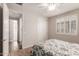 Bright bedroom featuring a window with shutters and closet at 22854 E Pummelos Rd, Queen Creek, AZ 85142