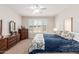 Bedroom with plantation shutters, a ceiling fan, and carpet flooring. Includes dressers and a comfortable bed at 22854 E Pummelos Rd, Queen Creek, AZ 85142