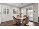 Bright dining area with modern lighting, contemporary table, and sliding glass doors that provide a seamless indoor/outdoor experience at 22854 E Pummelos Rd, Queen Creek, AZ 85142