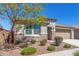 Attractive single-story house enhanced by desert landscaping, rock accents, and a two-car garage at 22854 E Pummelos Rd, Queen Creek, AZ 85142