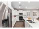 Modern kitchen featuring stainless steel appliances, white cabinets, and bright lighting for a functional cooking space at 22854 E Pummelos Rd, Queen Creek, AZ 85142