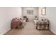 Comfortable living room with neutral walls and plush carpeting, bathed in natural light from a large window at 22854 E Pummelos Rd, Queen Creek, AZ 85142