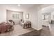 Cozy living room featuring neutral walls and hardwood floors, adjacent to a bright kitchen at 22854 E Pummelos Rd, Queen Creek, AZ 85142