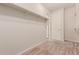 Spacious walk-in closet with ample shelving, bars and plush carpeting at 22854 E Pummelos Rd, Queen Creek, AZ 85142