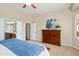 Cozy bedroom featuring a dresser, a ceiling fan, and an attached bathroom at 23123 N Cardenas Dr, Sun City West, AZ 85375