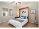 Inviting bedroom with two windows, a wall bed, and a ceiling fan at 23123 N Cardenas Dr, Sun City West, AZ 85375