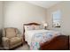 Inviting bedroom with a decorative bed and a comfortable armchair at 23123 N Cardenas Dr, Sun City West, AZ 85375