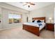 Comfortable bedroom with carpet, a large window, and ceiling fan at 23123 N Cardenas Dr, Sun City West, AZ 85375