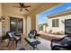 Relaxing covered patio with outdoor seating and a ceiling fan at 23123 N Cardenas Dr, Sun City West, AZ 85375