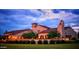 Stunning home exterior with tile roof, lush landscaping, and charming architectural details at twilight at 23123 N Cardenas Dr, Sun City West, AZ 85375