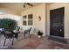 Covered front porch showcasing tile flooring, outdoor seating, and stylish decor at 23123 N Cardenas Dr, Sun City West, AZ 85375