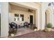 Charming front porch featuring desert plants, outdoor seating and a ceiling fan for extra comfort at 23123 N Cardenas Dr, Sun City West, AZ 85375