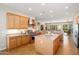 Spacious kitchen featuring stainless steel appliances, center island, and a connected living space at 23123 N Cardenas Dr, Sun City West, AZ 85375