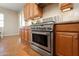 Stainless steel oven with wooden cabinets and tile flooring for a modern and stylish kitchen at 23123 N Cardenas Dr, Sun City West, AZ 85375