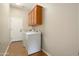 Well-organized laundry room with cabinets and tile floor at 23123 N Cardenas Dr, Sun City West, AZ 85375