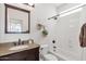 Cozy bathroom with granite countertop, shower-tub combo, and decorative accents at 2417 W Apache Rain Rd, Phoenix, AZ 85085