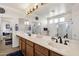 Bright bathroom features a double sink vanity, walk-in shower, soaking tub, and access to bedroom at 2417 W Apache Rain Rd, Phoenix, AZ 85085