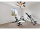 A well-lit bedroom features exercise equipment and a ceiling fan at 2417 W Apache Rain Rd, Phoenix, AZ 85085