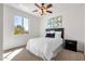 Bright bedroom with ceiling fan, window with outside view, and adjacent nightstand at 2417 W Apache Rain Rd, Phoenix, AZ 85085