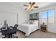 Cozy bedroom featuring a ceiling fan, window, and adjacent workstation at 2417 W Apache Rain Rd, Phoenix, AZ 85085