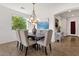 Bright dining room with large window and stylish chandelier, perfect for Gathering meals at 2417 W Apache Rain Rd, Phoenix, AZ 85085