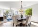 Elegant dining area with a chandelier, seating for six, and open-concept design at 2417 W Apache Rain Rd, Phoenix, AZ 85085