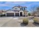 Stunning two-story home with three-car garage, desert landscaping, and charming architectural details at 2417 W Apache Rain Rd, Phoenix, AZ 85085