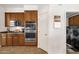 Well-equipped kitchen featuring stainless steel double ovens and direct access to the laundry room at 2417 W Apache Rain Rd, Phoenix, AZ 85085