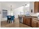 Open kitchen with stainless steel appliances and granite countertops, seamlessly flowing into the dining room at 2417 W Apache Rain Rd, Phoenix, AZ 85085