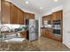 Kitchen with stainless steel appliances, including a double oven, and warm wood cabinetry at 2417 W Apache Rain Rd, Phoenix, AZ 85085