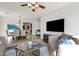 Cozy living room flows into the dining area with modern ceiling fan and large television at 2417 W Apache Rain Rd, Phoenix, AZ 85085