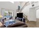 Bright living room featuring soaring ceilings, staircase and sliding doors to pool at 2417 W Apache Rain Rd, Phoenix, AZ 85085