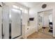 Bright main bathroom featuring a glass-enclosed shower, soaking tub, and mirrored closet at 2417 W Apache Rain Rd, Phoenix, AZ 85085