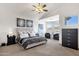 Serene main bedroom with tufted headboard, neutral tones, and plenty of natural light at 2417 W Apache Rain Rd, Phoenix, AZ 85085